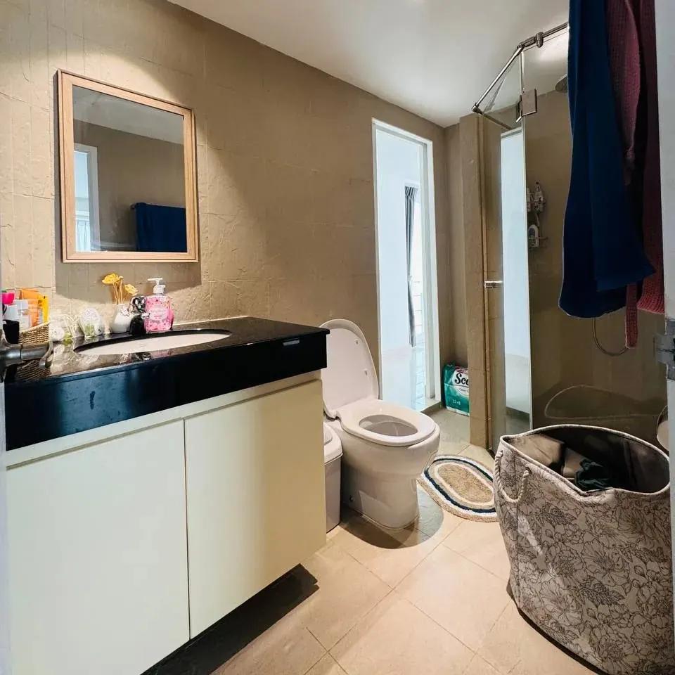 Bathroom before editing: clothes on the shower door and a laundry basket in the frame